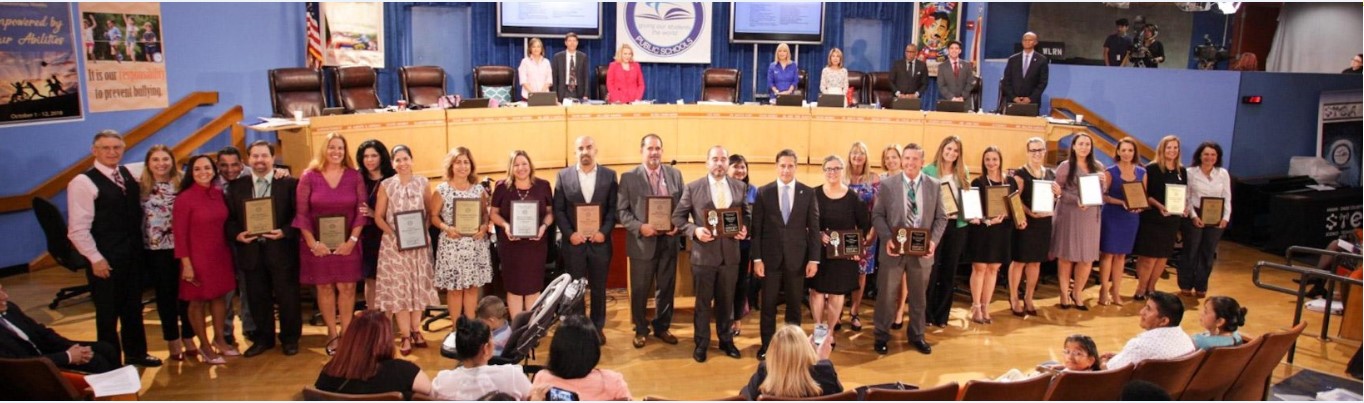 Calusa Elementary educators receiving the STEM designation award on stage at the Miami-Dade School Board auditorium